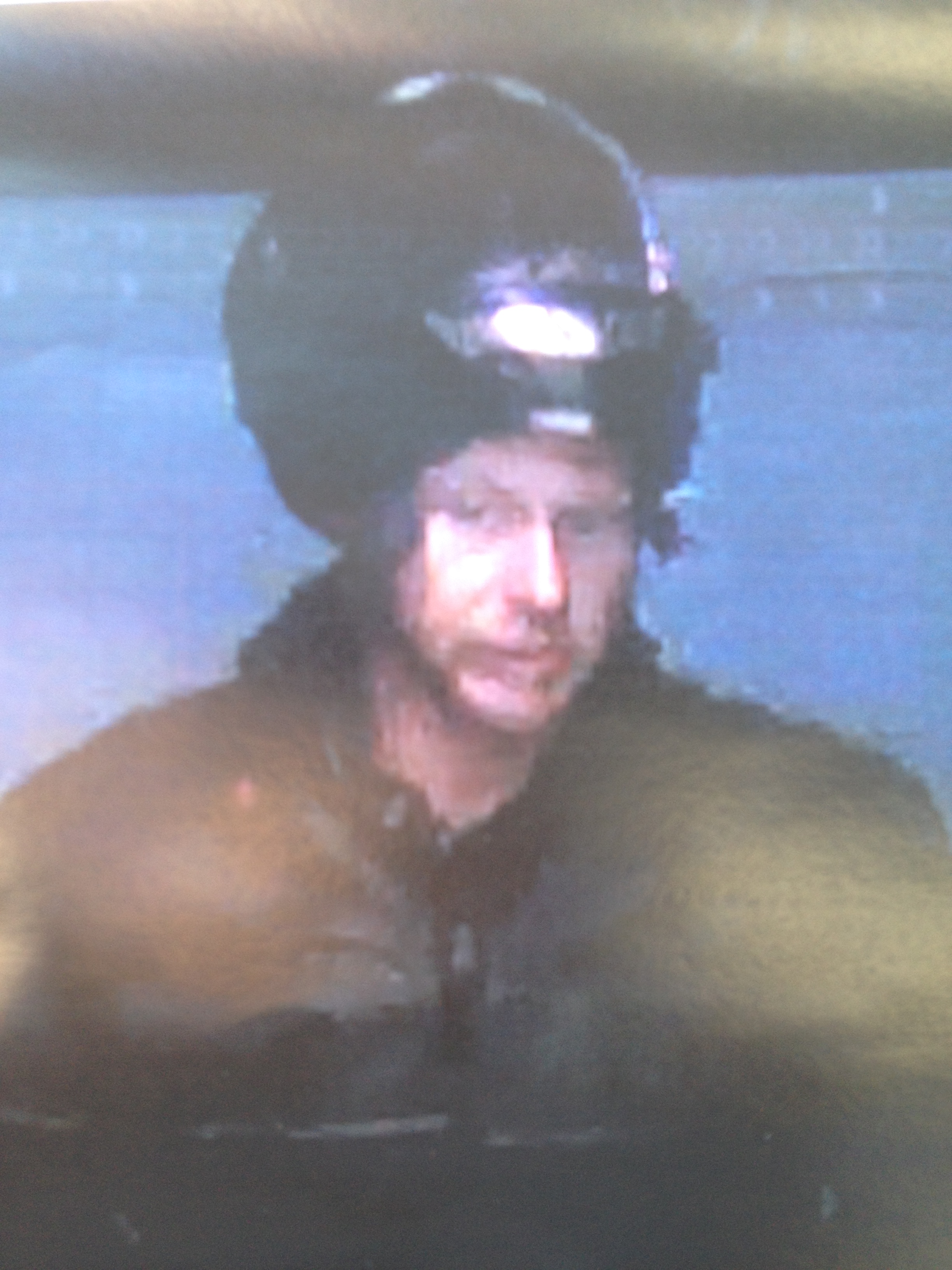 caucasian male with motorcycle helmet pushed up on head